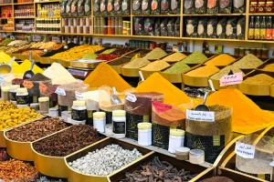 Traditional souq stall with bowls of spices, dried herbs, and seasonings at Dubai Spice Souk.