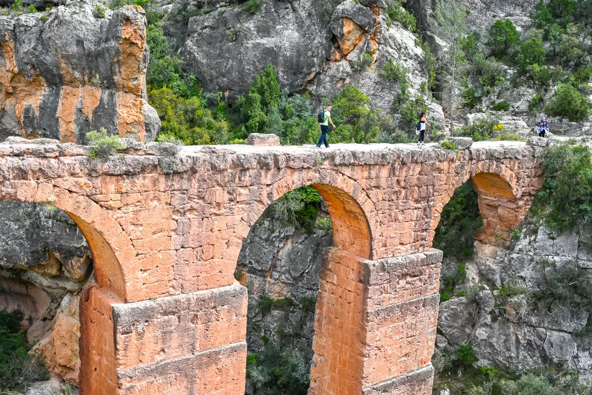 Ancient Roman aqueduct standing above a forested gorge near Chelva.