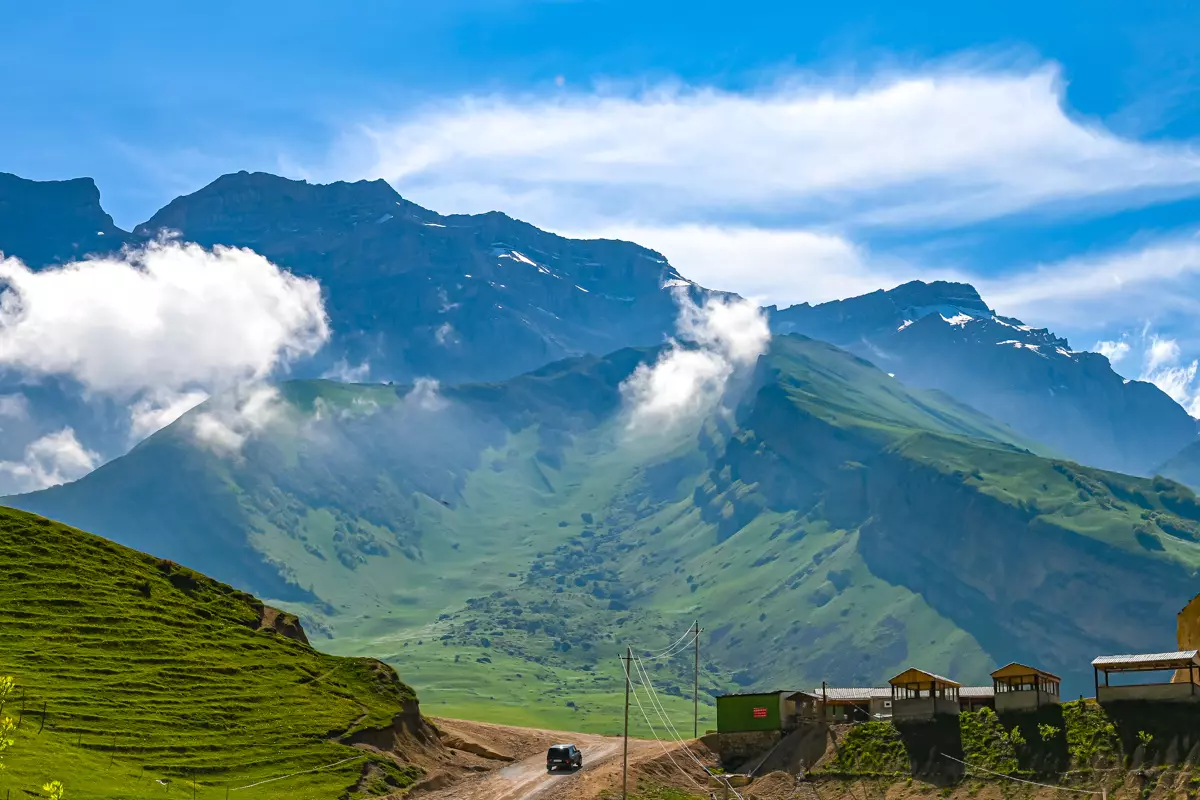 Moody sky over Laza with clouds drifting through the peaks.