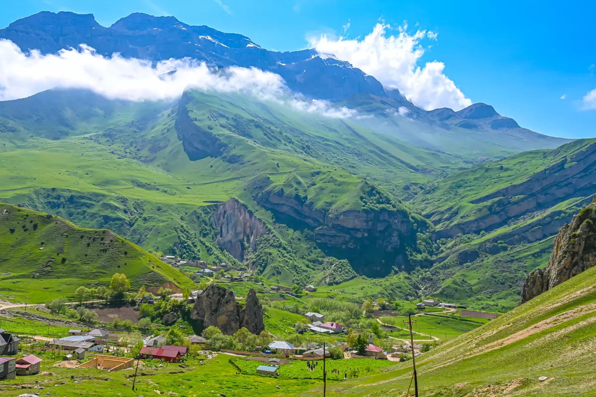 Aerial view of Laza village in Azerbaijan, surrounded by dramatic cliffs and lush green mountains