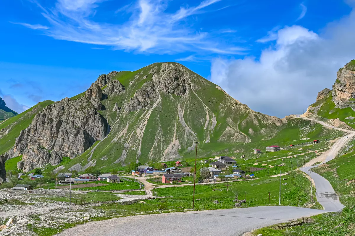 Wide-angle view of Laza village nestled between spring mountains.