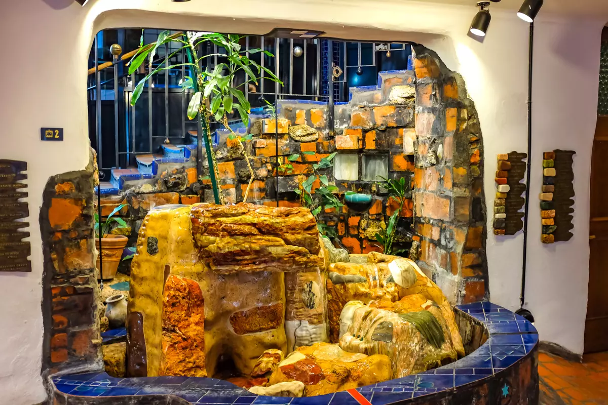 Hundertwasser Museum Vienna interior with colorful fountain and brick wall