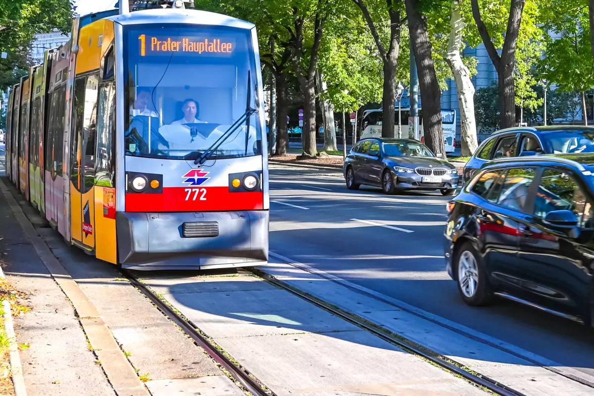Red tram driving through the streets of Vienna