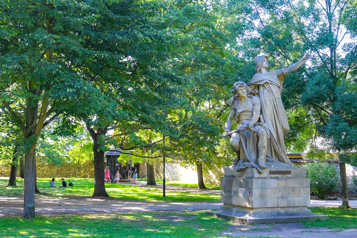 Stone statues surrounded by greenery in Vysehrad Park