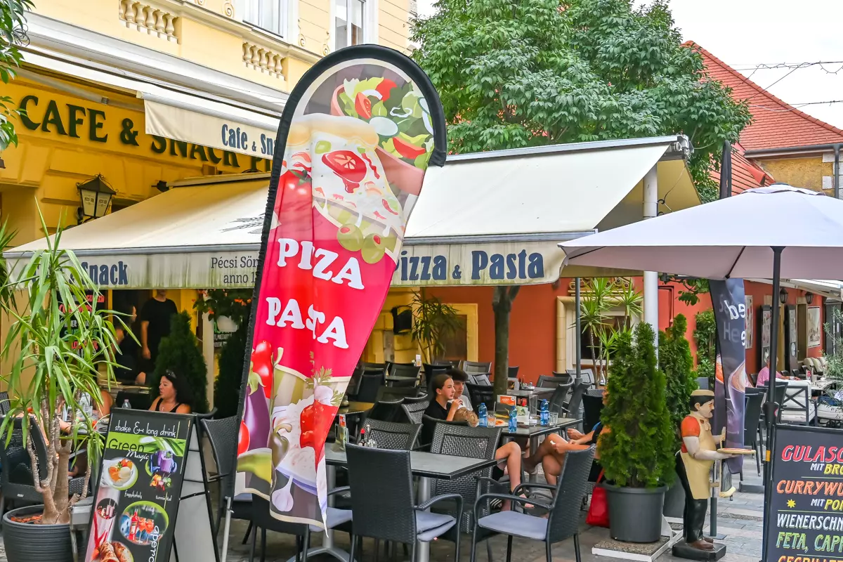 Traditional Hungarian restaurant with tables on a sunny street in Keszthely