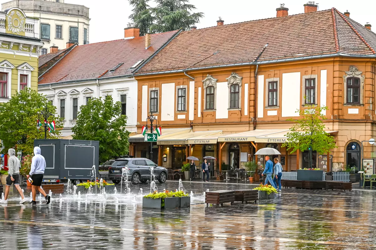 Rain-soaked Dobó Square in Eger reflecting colorful buildings