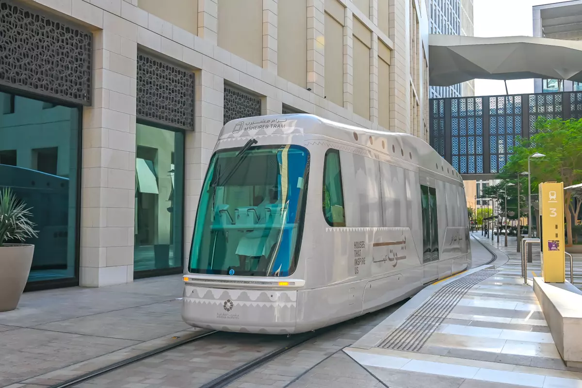 Msheireb tram arriving at a modern street stop in city