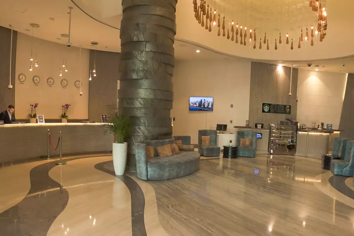 Modern lobby of the DoubleTree by Hilton Doha – Old Town, featuring the reception desk, seating area, and decorative lighting