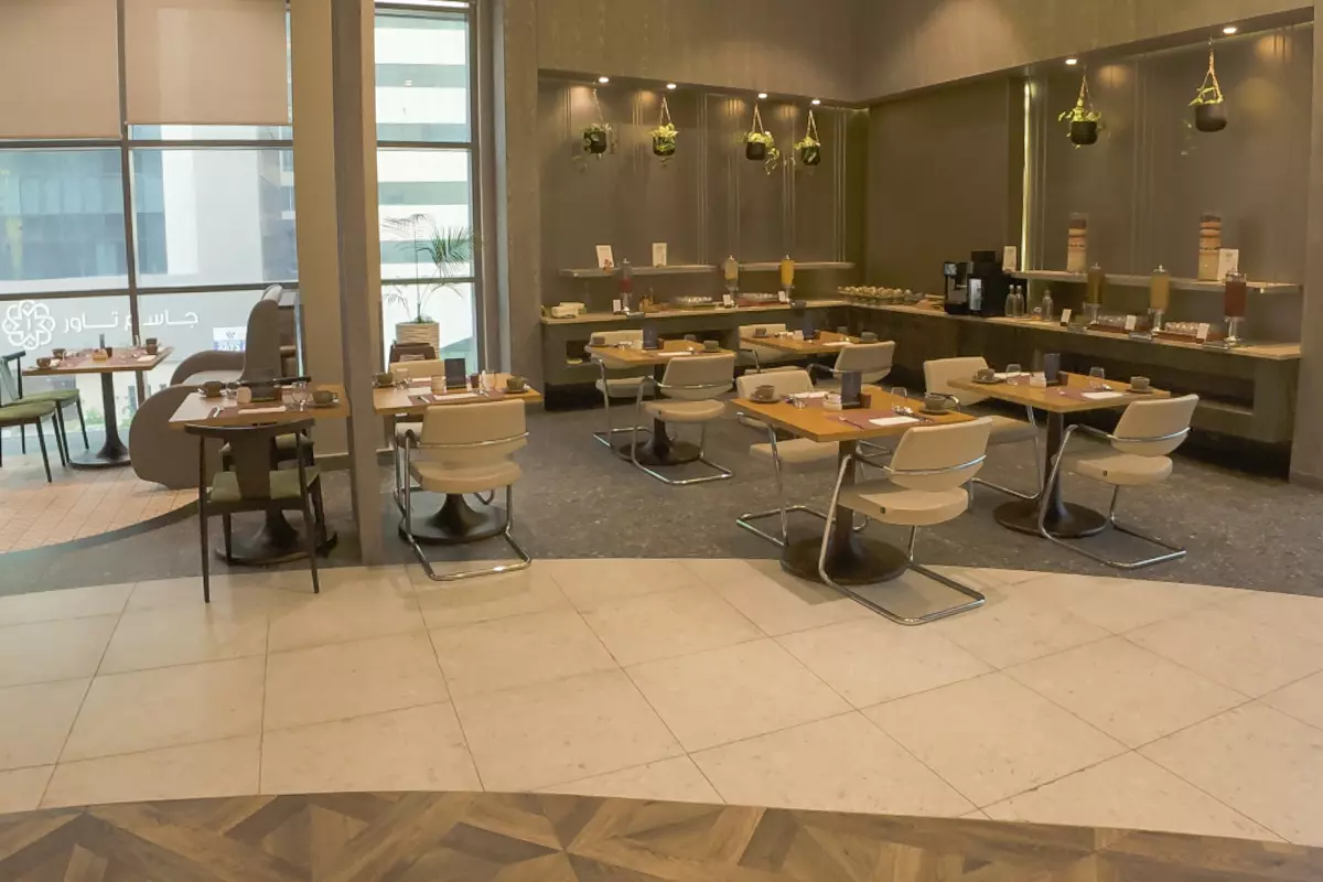 L2 Restaurant at DoubleTree by Hilton Doha – Old Town featuring modern dining tables, buffet area, and natural light from large windows