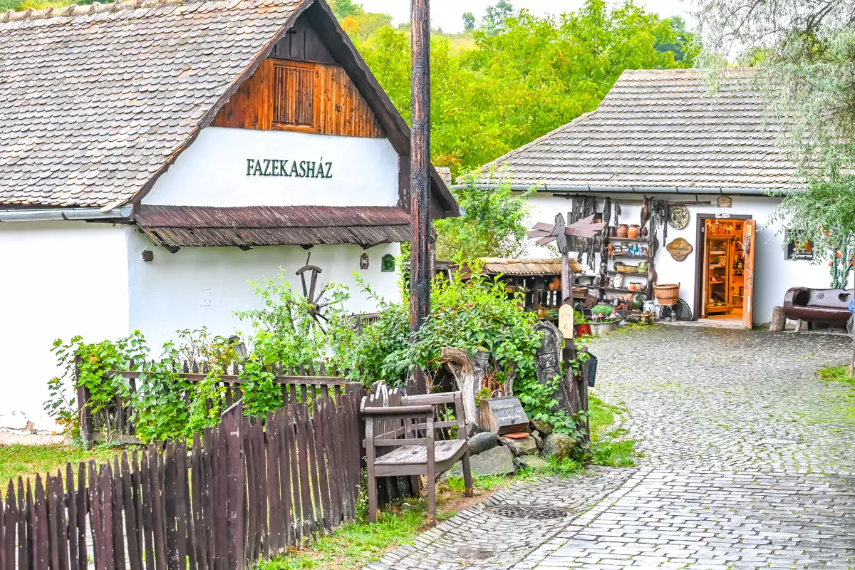 Traditional village house in Hollókő showcasing local ceramic crafts.