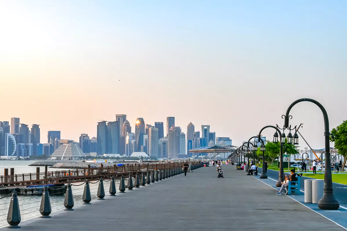 People stroll along Doha’s waterfront promenade, a safe, secure, and welcoming spot for tourists